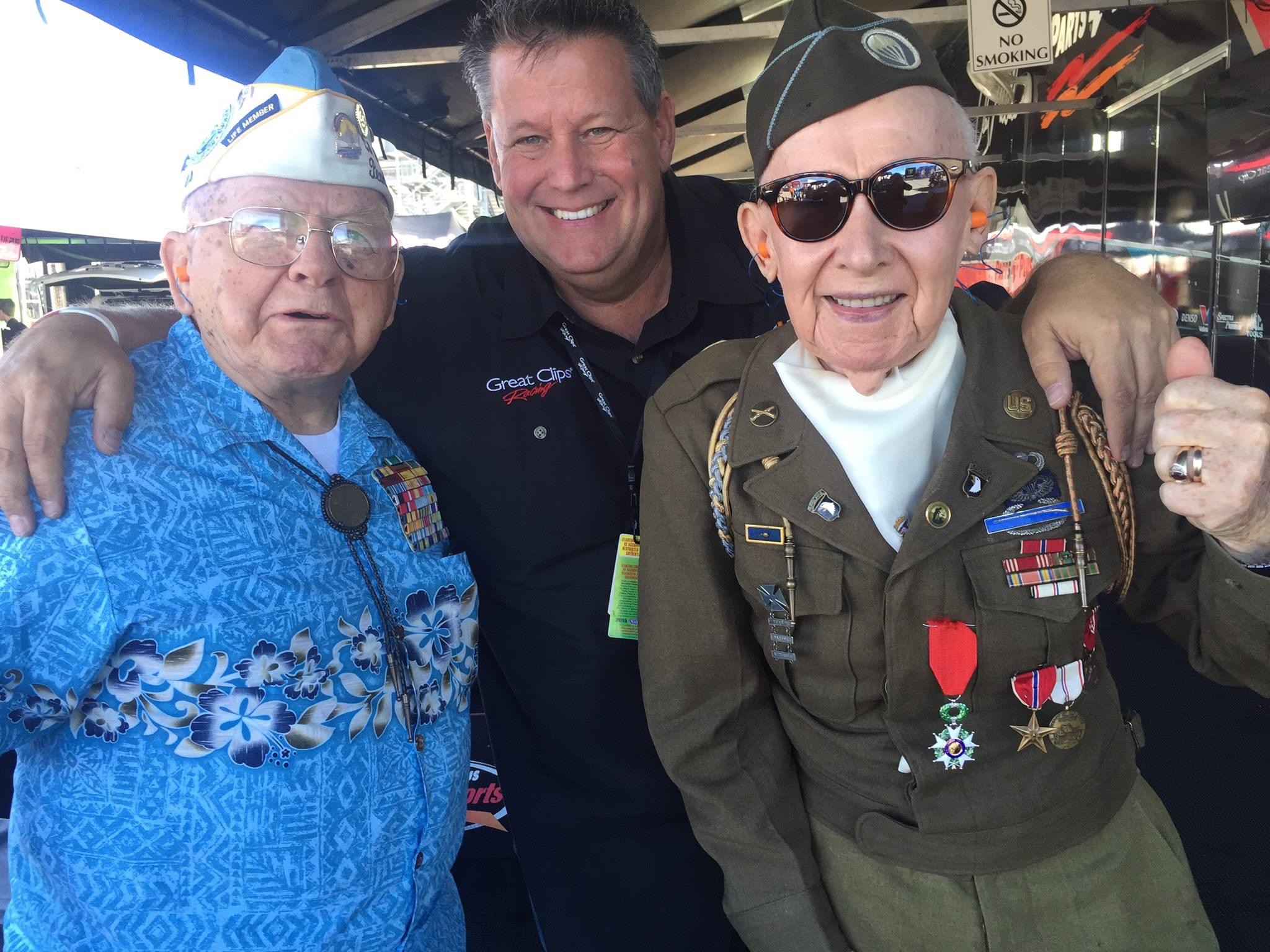 Doug stringer and joseph riley posing for a picture with trackside veterans