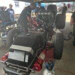 A Mechanic working on the engine of drag car